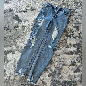 High waisted button up light wash distressed jeans, raw hem